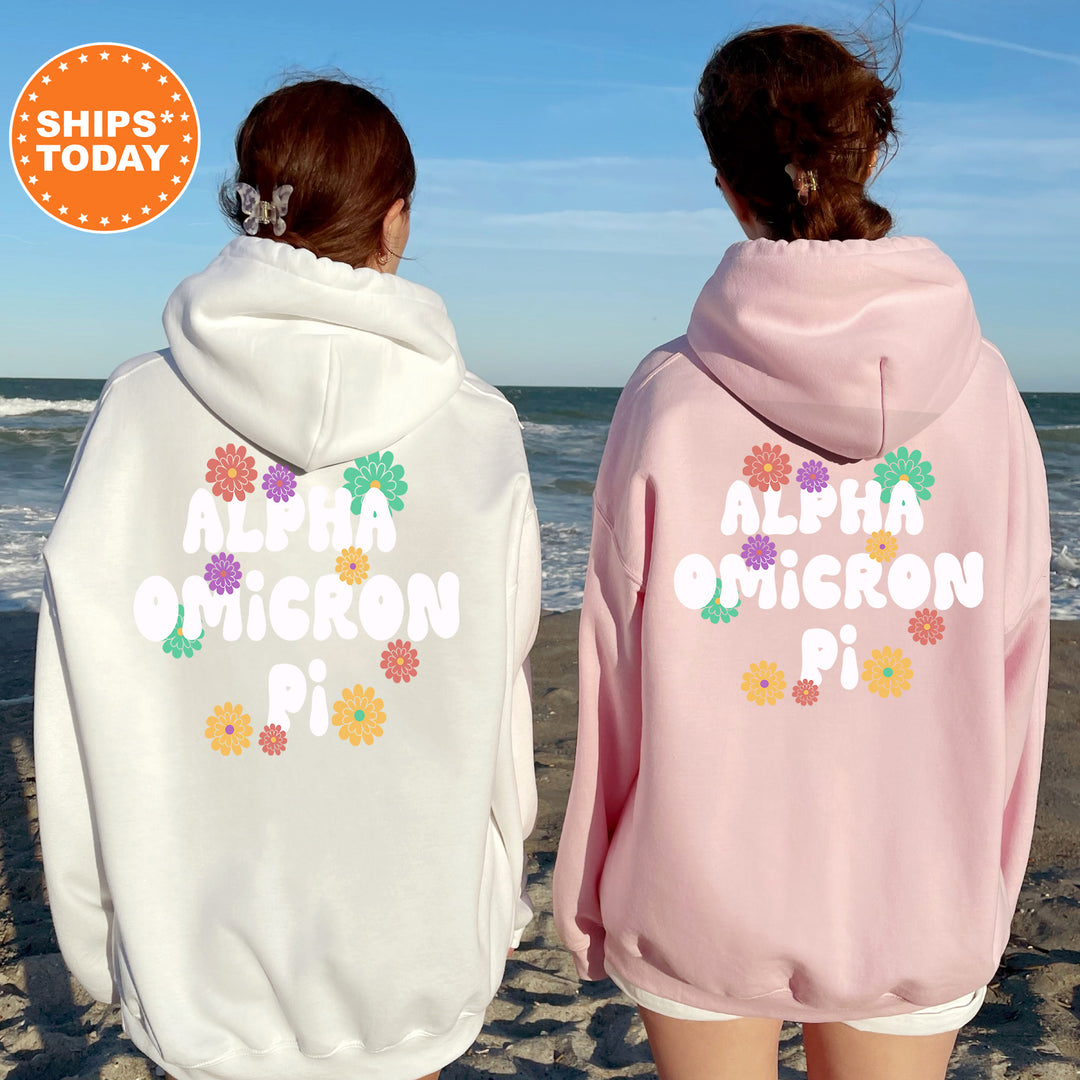 two girls wearing matching sweatshirts on the beach