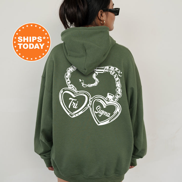 A person wearing a green hoodie with white text and graphics on the back.