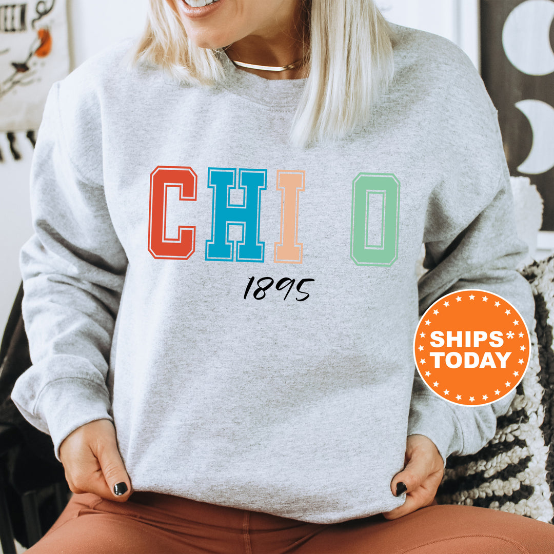 a woman sitting in a chair wearing a sweatshirt with the word chicago printed on it
