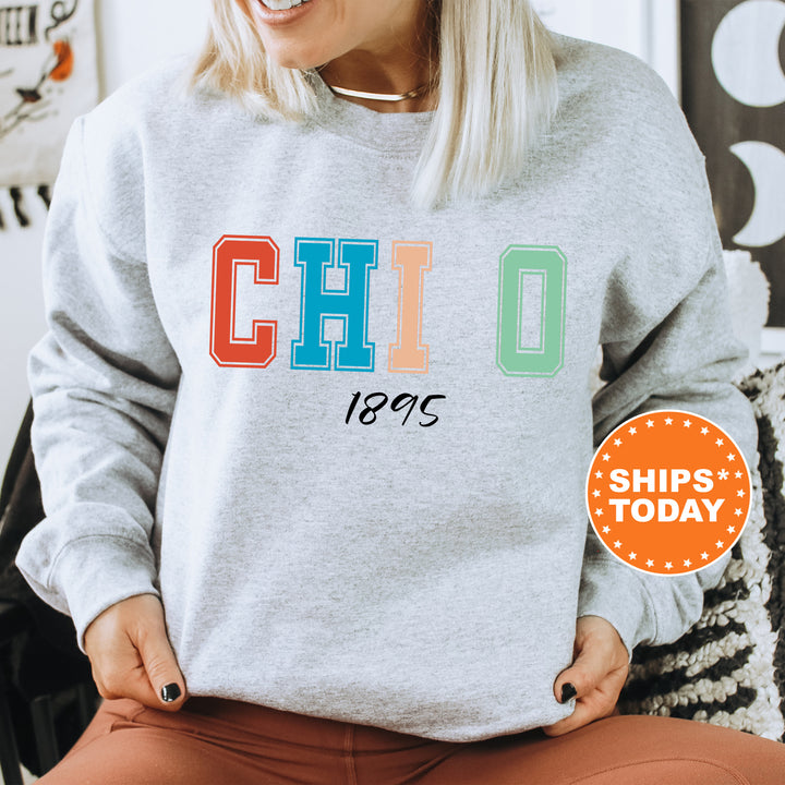 a woman sitting in a chair wearing a sweatshirt with the word chicago printed on it
