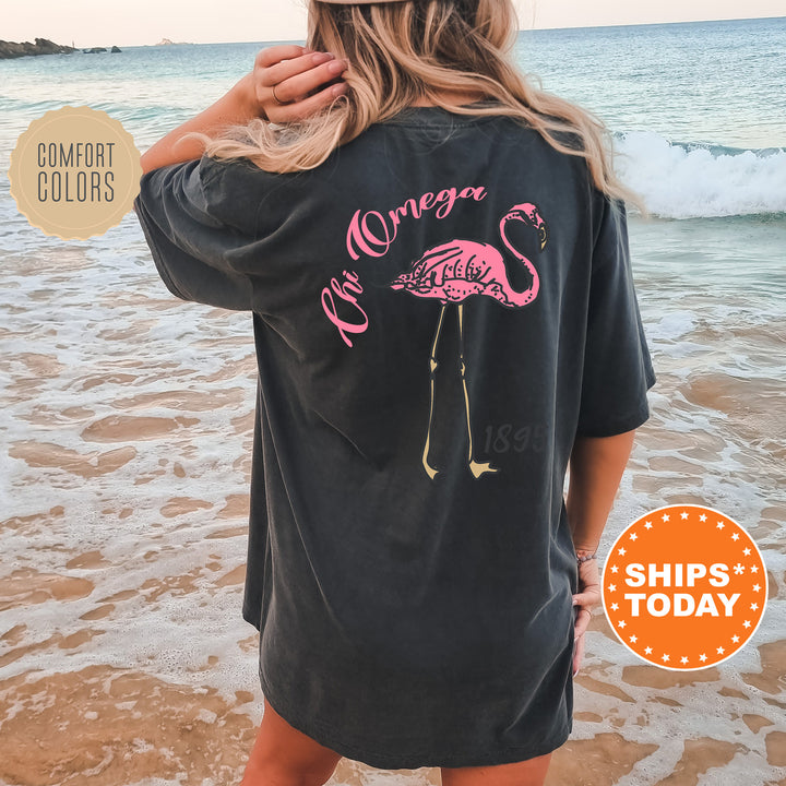 a woman wearing a black shirt with a pink flamingo on it