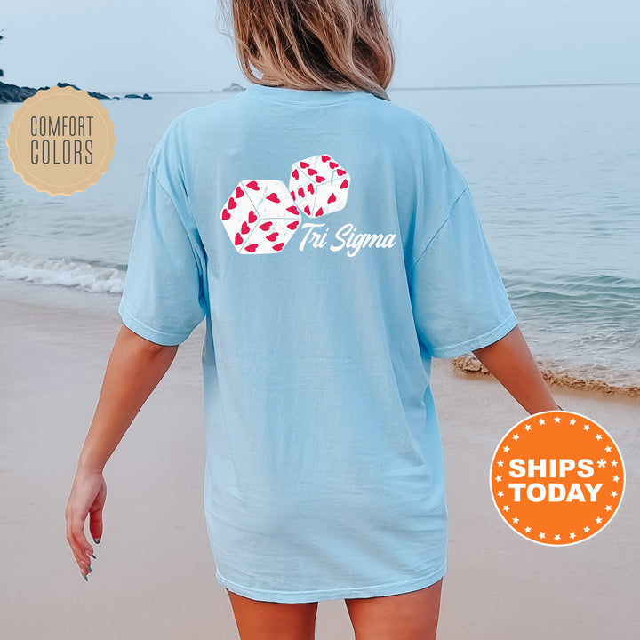 a woman walking on the beach wearing a blue shirt