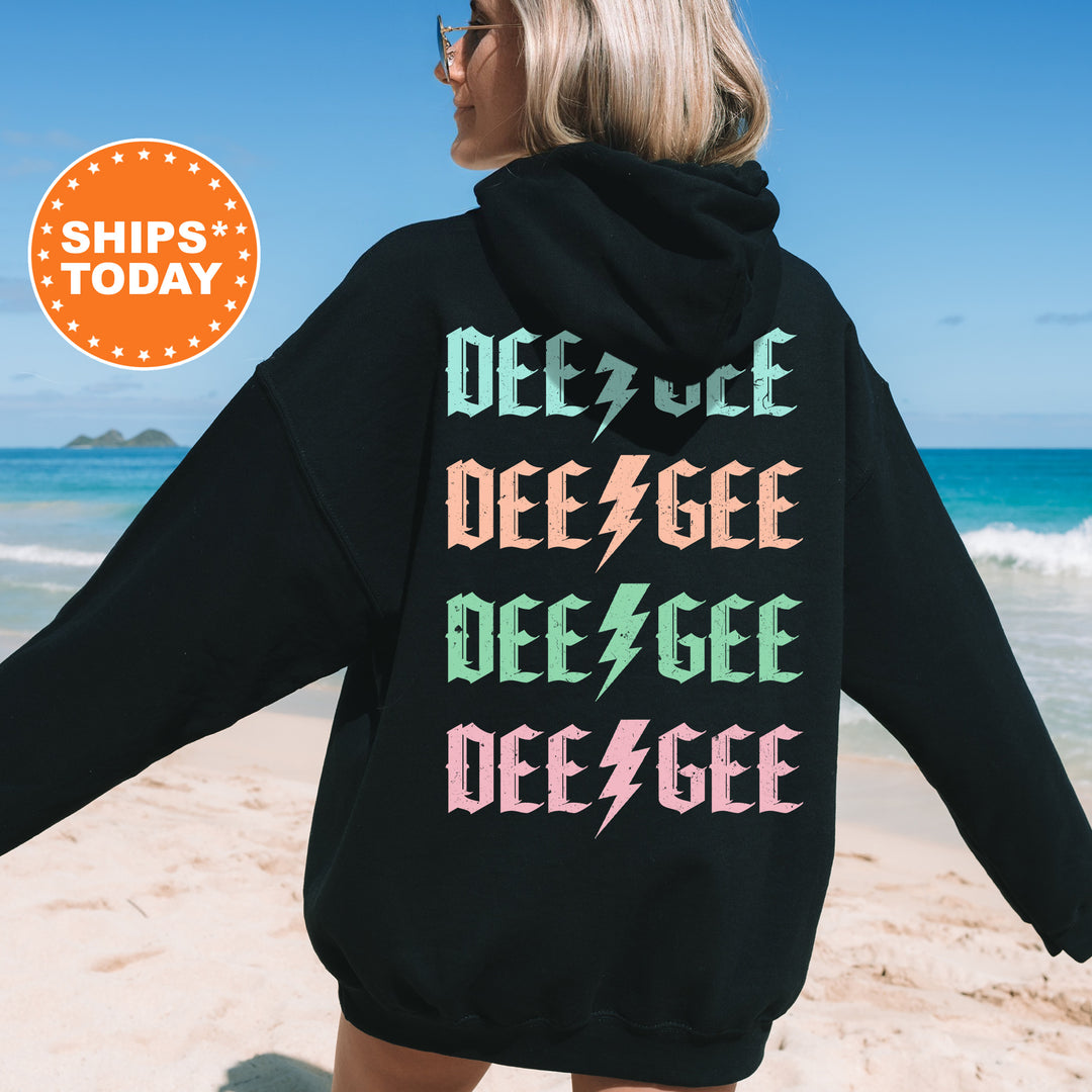 a woman in a black hoodie on the beach