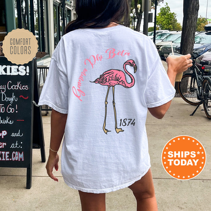 a woman walking down a sidewalk with a pink flamingo shirt on