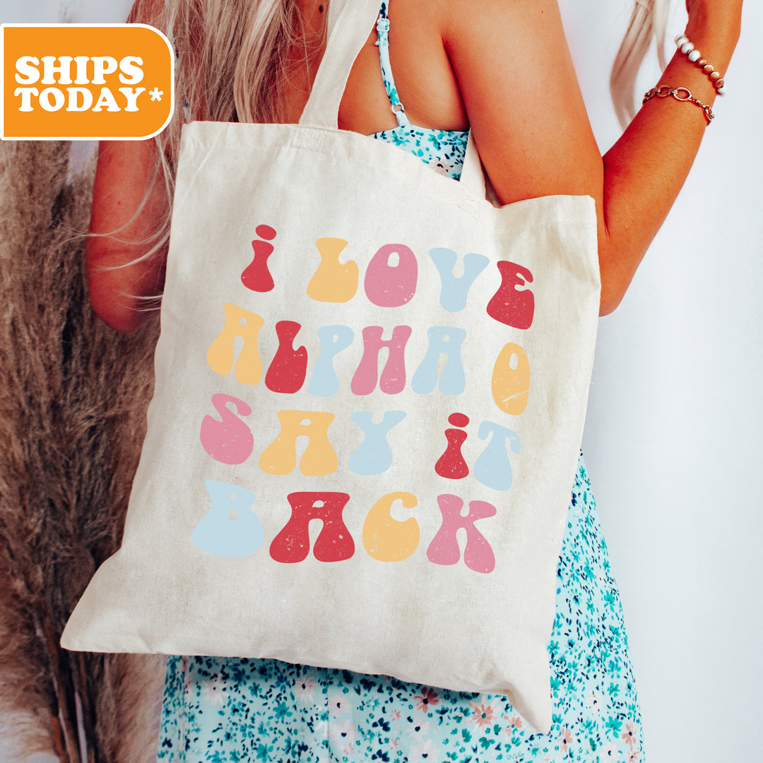 a woman holding a tote bag with a message on it