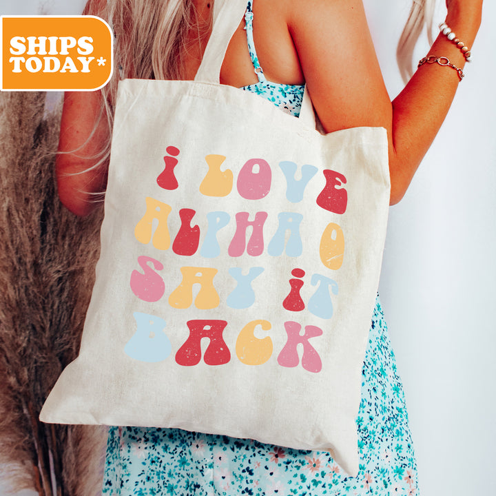 a woman holding a tote bag with a message on it