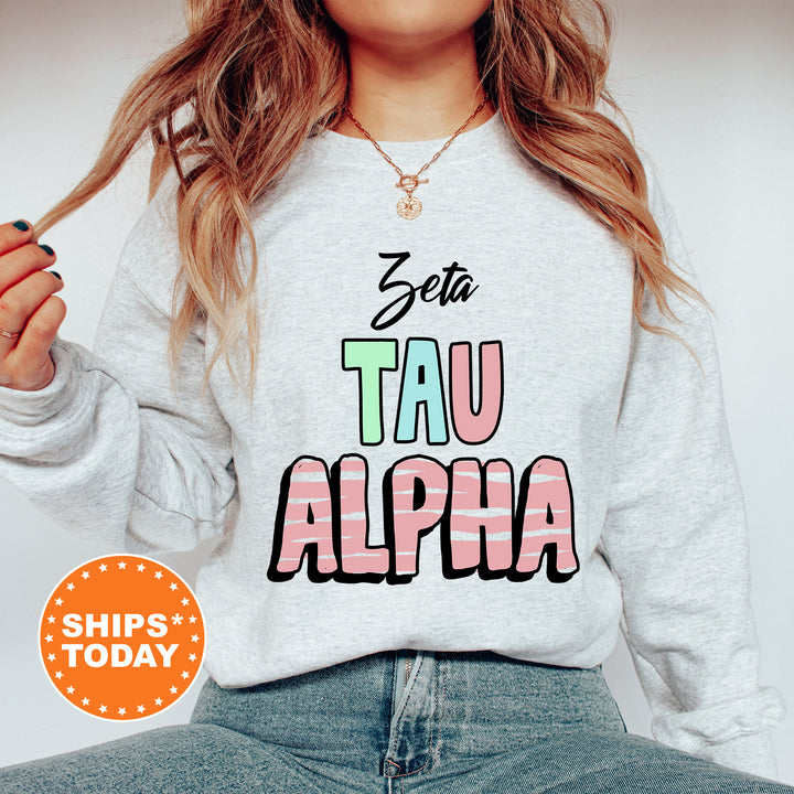 a woman wearing a sweatshirt with the words tau alpha printed on it