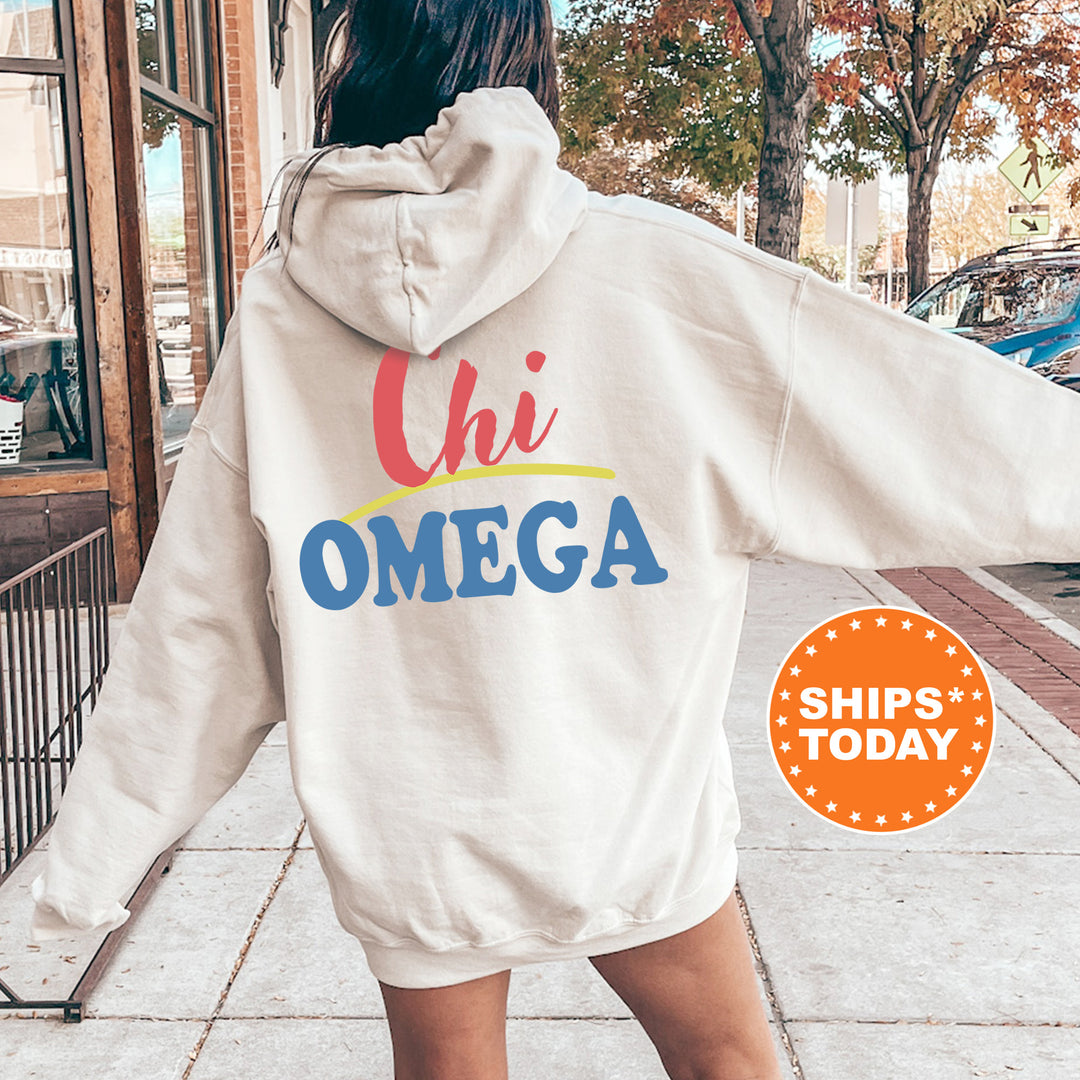 A person wearing a white hoodie with the text "Chi Omega" printed on it, standing on a sidewalk with a car and trees in the background.