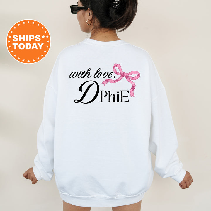 a woman wearing a white sweatshirt with a pink ribbon on it