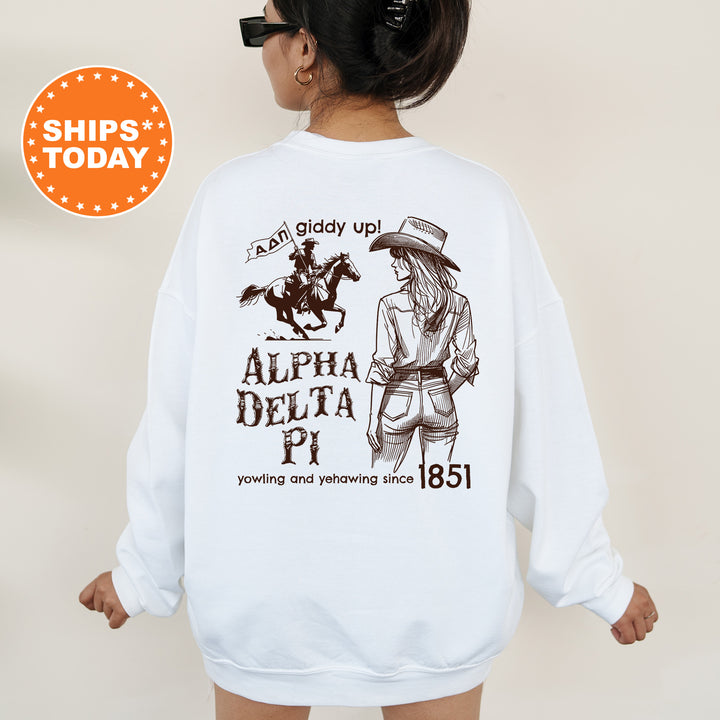 a woman wearing a white sweatshirt with a horse and rider on it