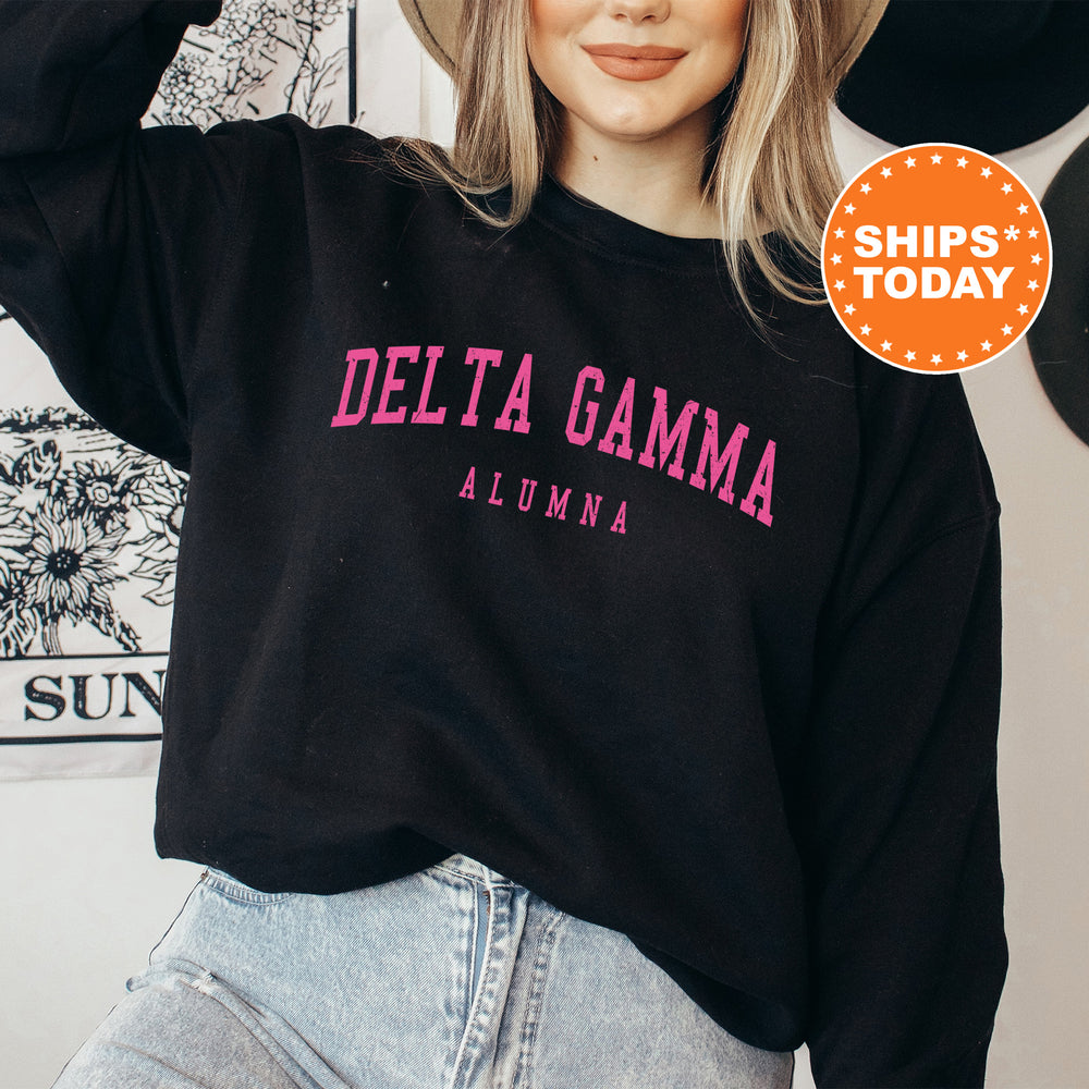 a woman wearing a black sweatshirt with the delta gama on it