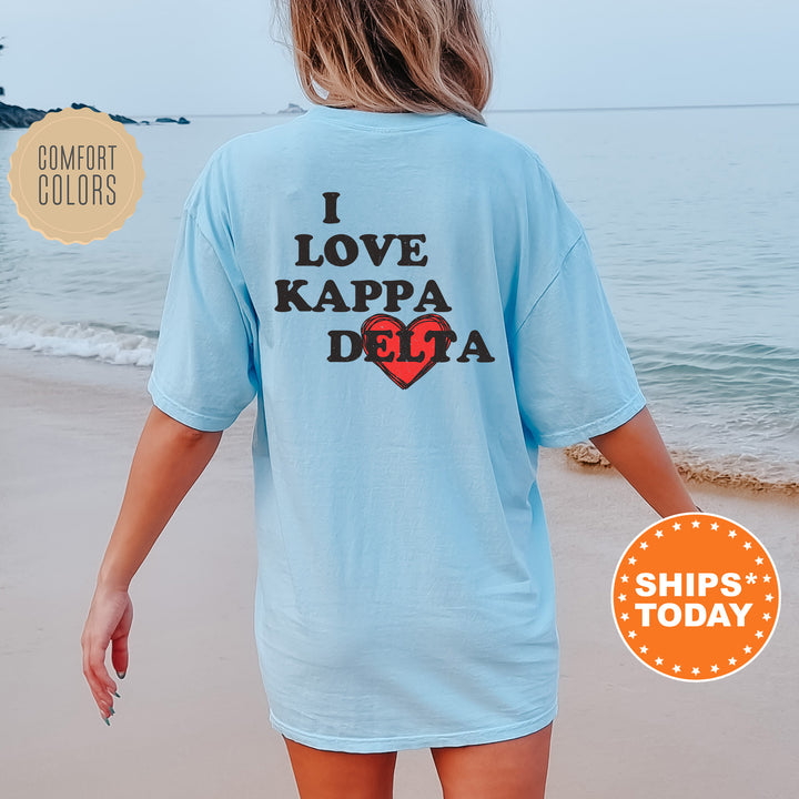 a woman walking on the beach wearing a shirt that says i love kapa de
