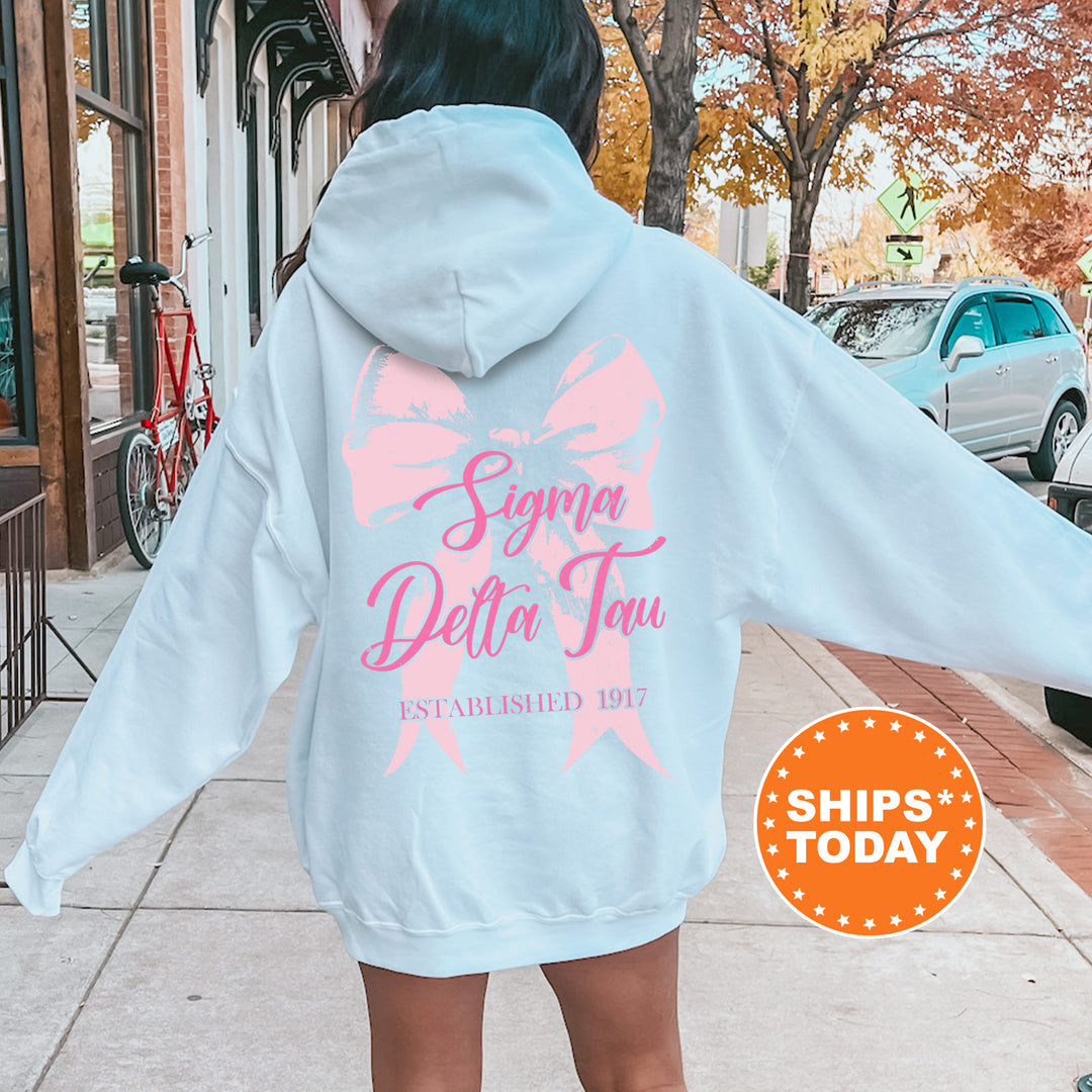 a woman in a pink and white hoodie is walking down the street