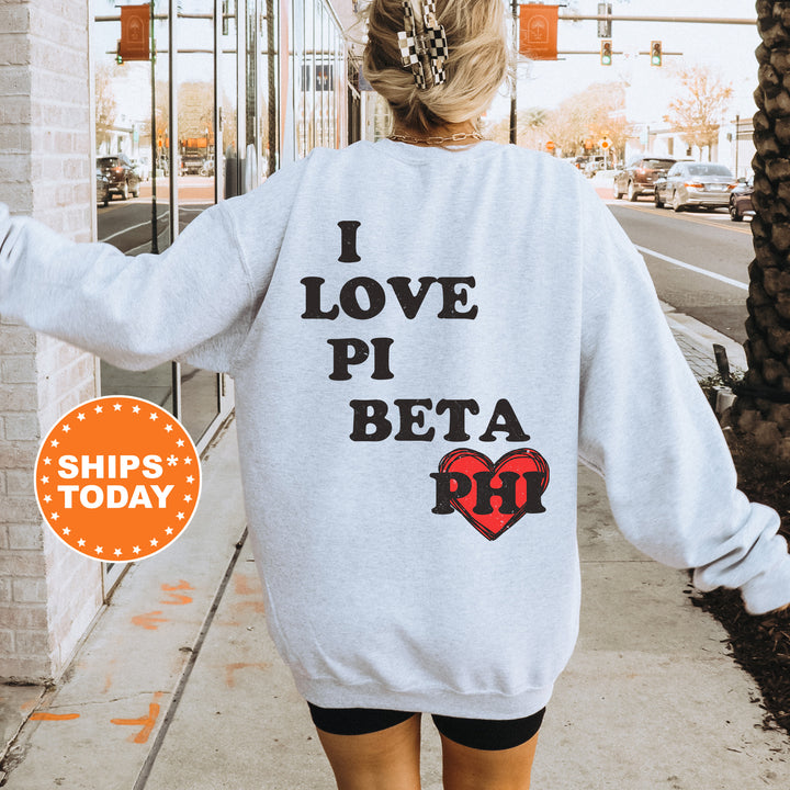 a woman walking down a sidewalk wearing a sweatshirt that says i love pi beta