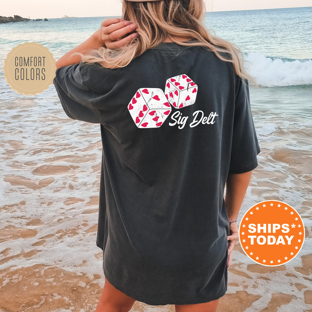 a woman standing on a beach wearing a black shirt