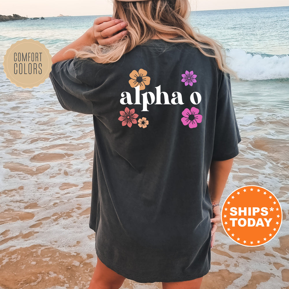 a woman standing on a beach wearing a black shirt