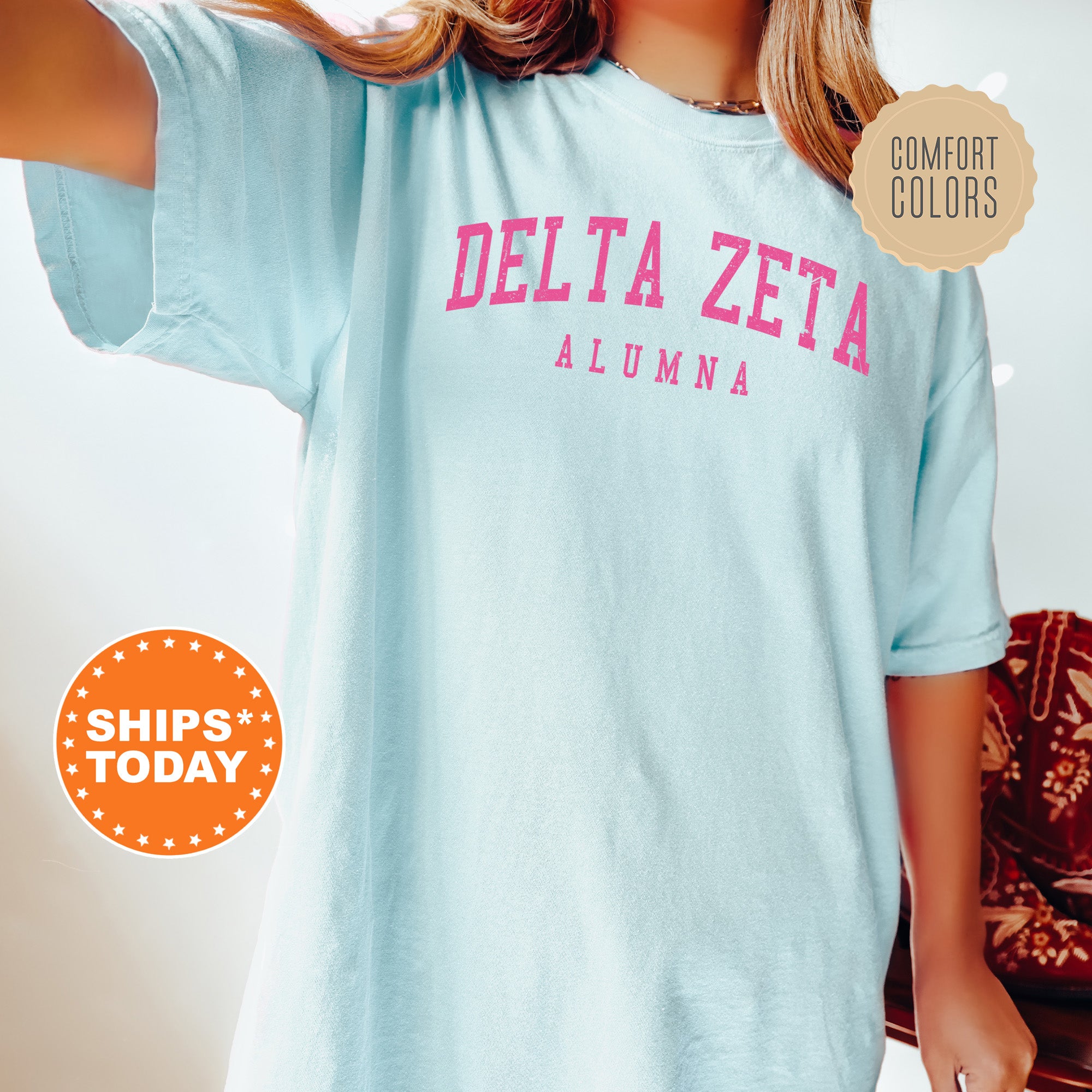 a woman wearing a blue delta zeta t - shirt