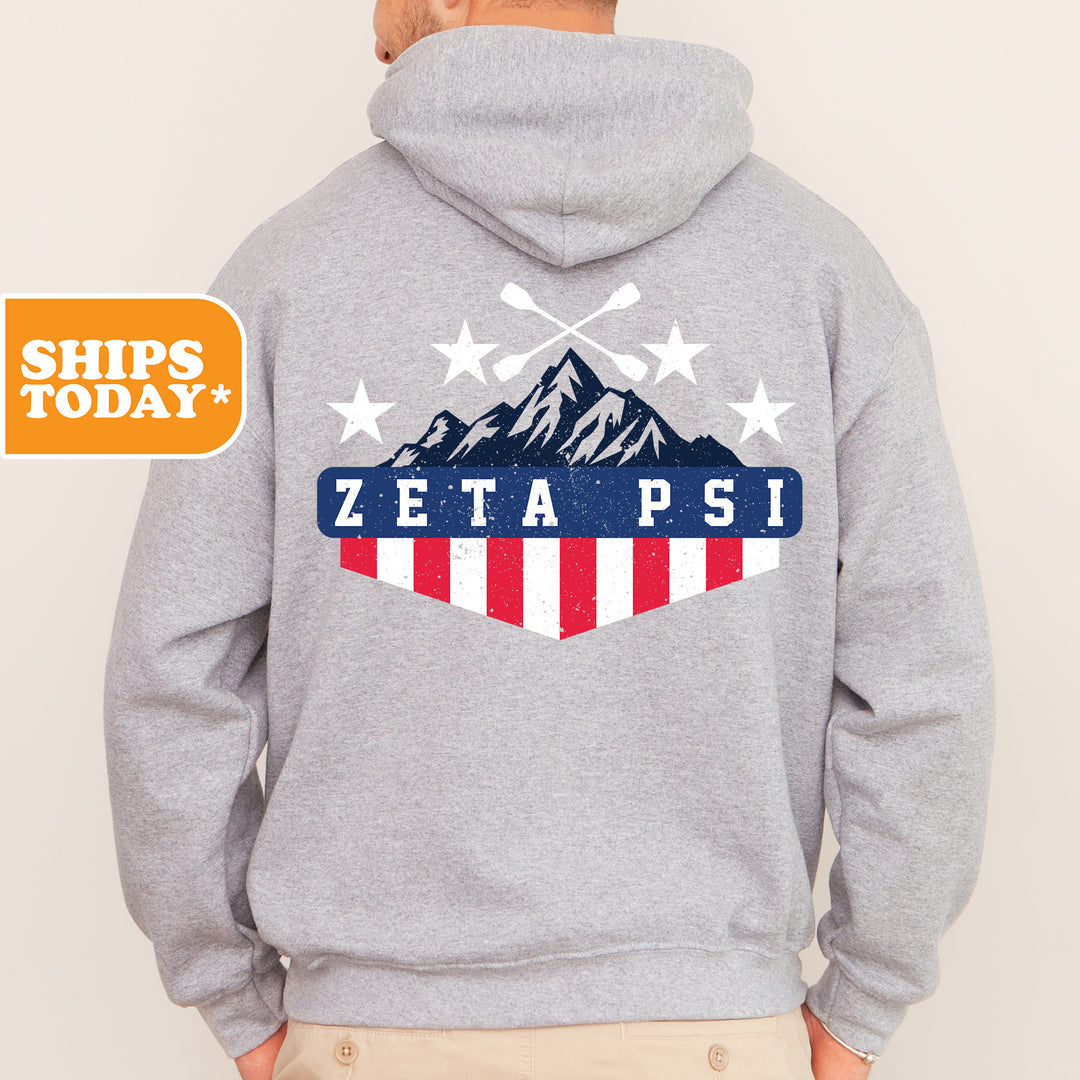 a man in a gray hoodie with the words zeta psi on it