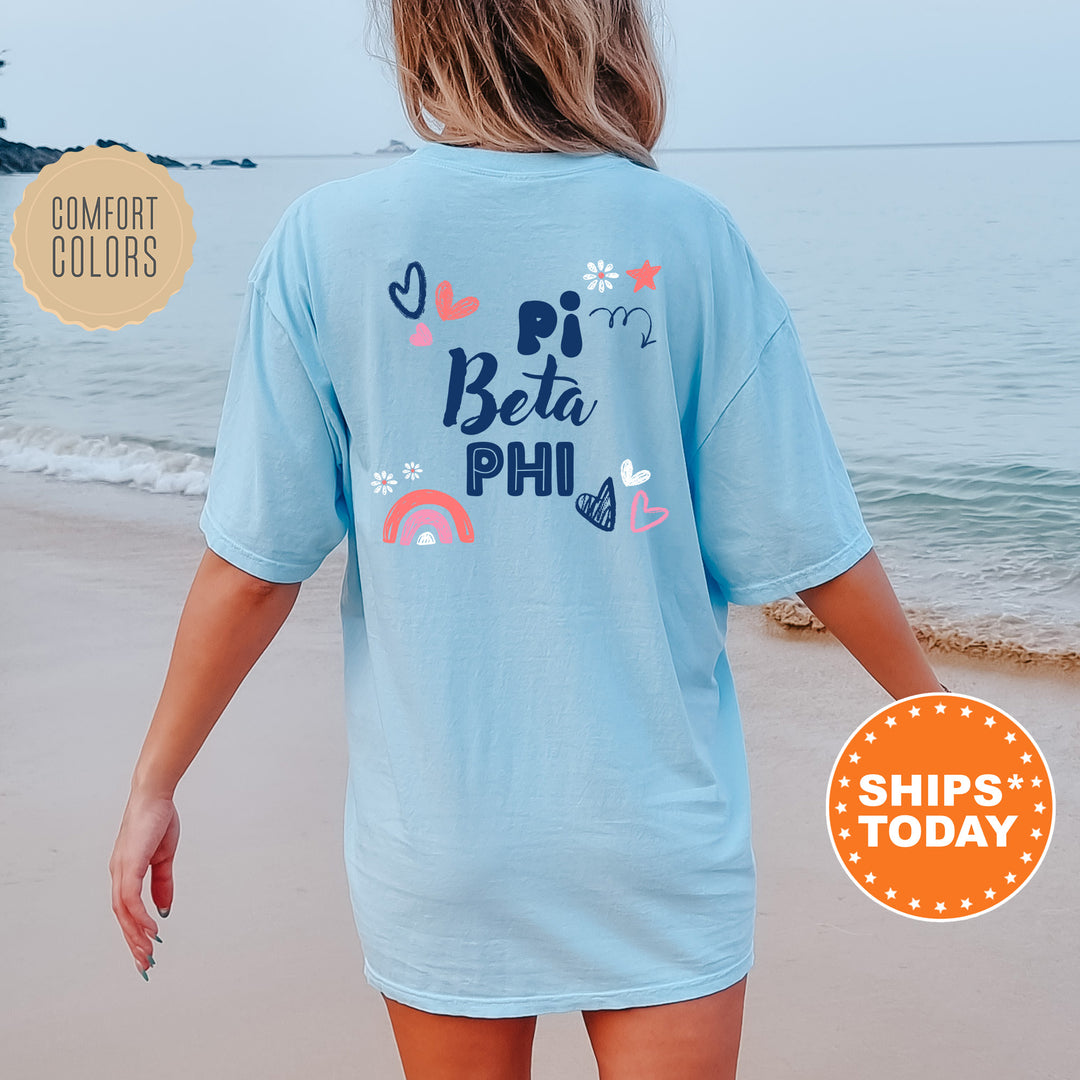 a woman walking on the beach in a blue shirt
