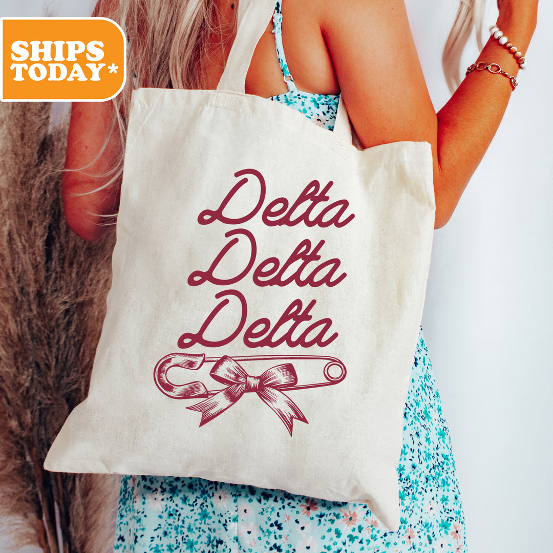 a woman holding a white bag with the words delta delta on it