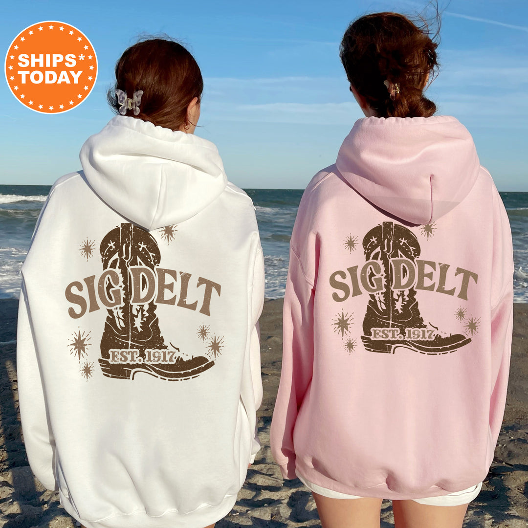 two women in pink and white sweatshirts on the beach