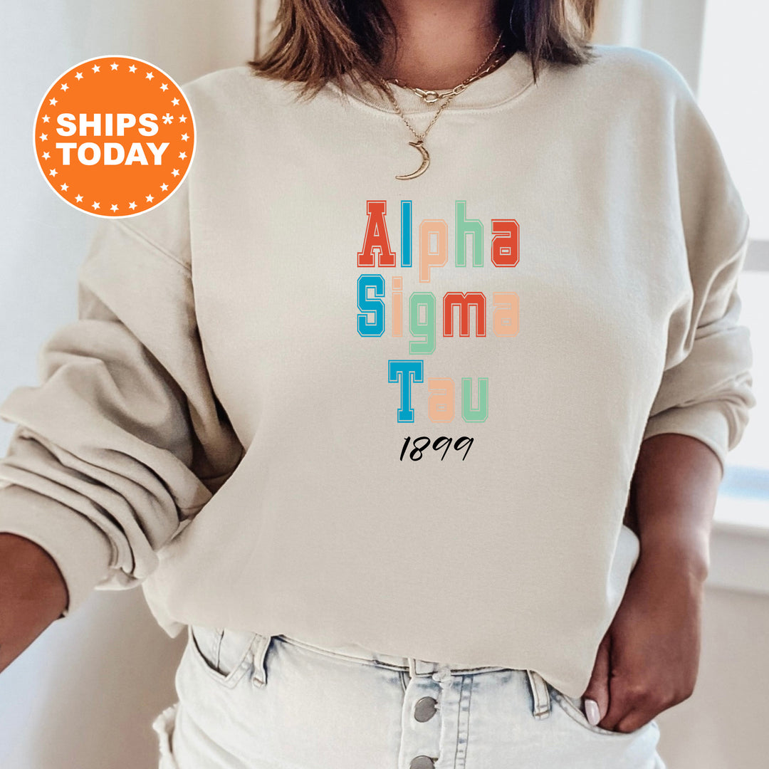 a woman wearing a sweatshirt that says, alpha sigma tau