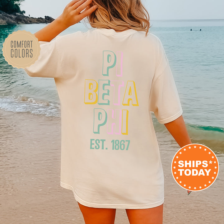 a woman standing on a beach wearing a t - shirt