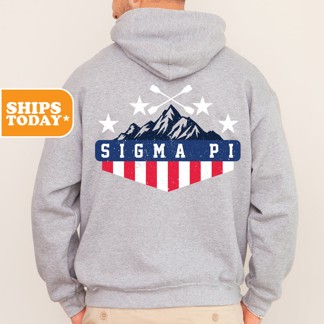 a man wearing a gray hoodie with the american flag on it