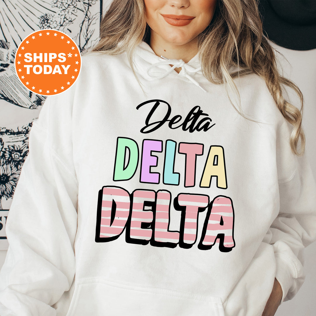 a woman wearing a white hoodie with the words delta delta printed on it