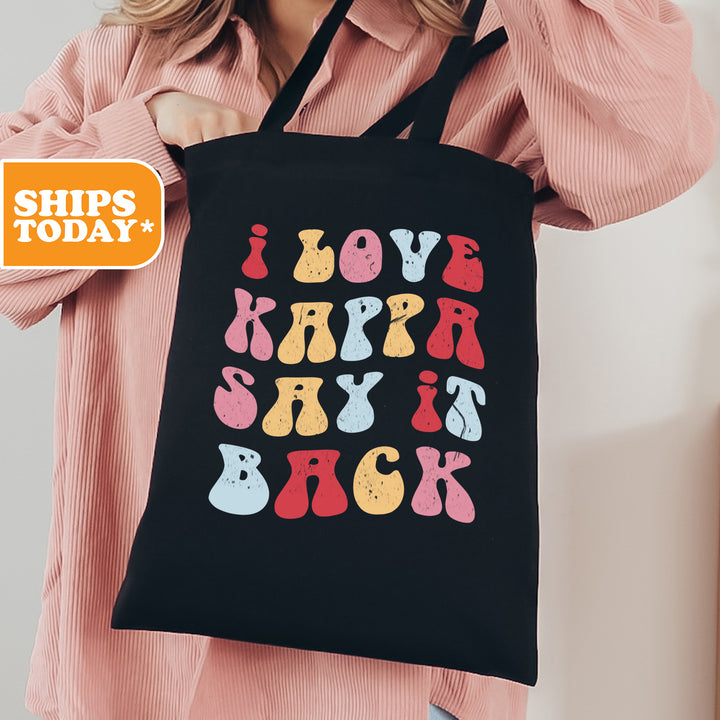 a woman holding a black shopping bag with the words love, happy, and back