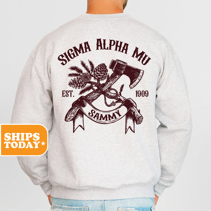 a man wearing a sweatshirt with a hammer and pine cones on it