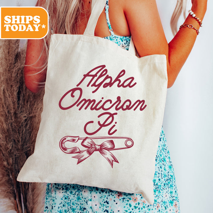 a woman holding a tote bag with the words aphel omicson pi