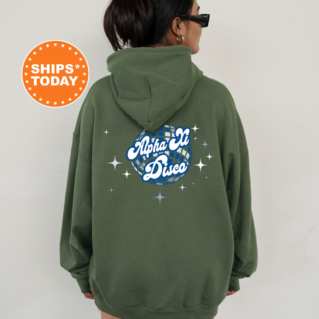A person wearing a green hoodie with a graphic design on the back.