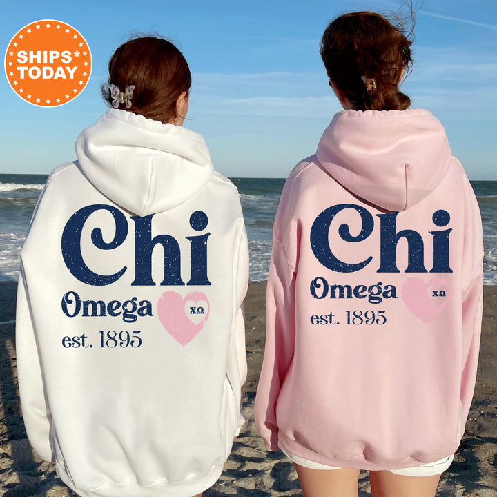 two women wearing matching sweatshirts on the beach