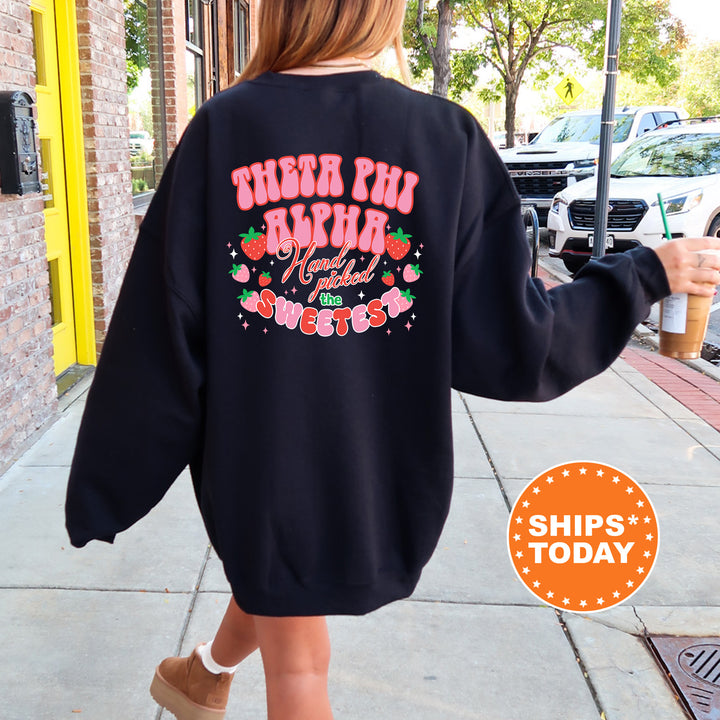 a woman walking down a sidewalk wearing a sweatshirt