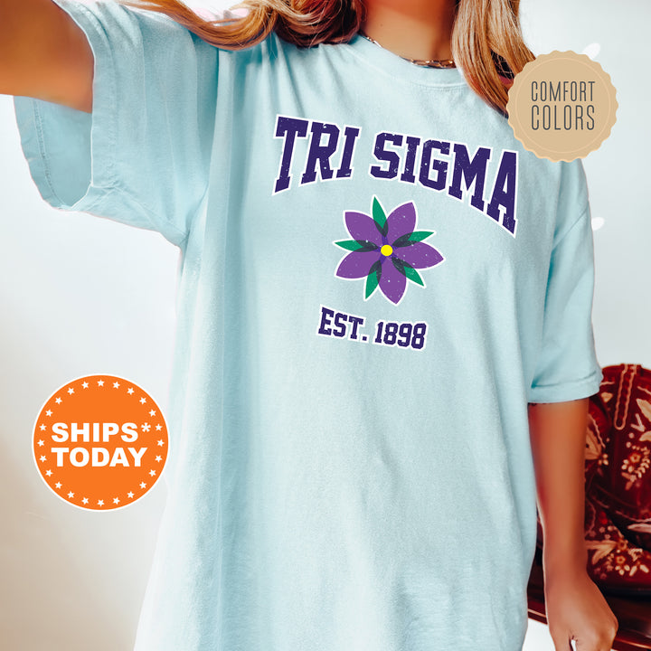 a woman wearing a blue shirt with a flower on it