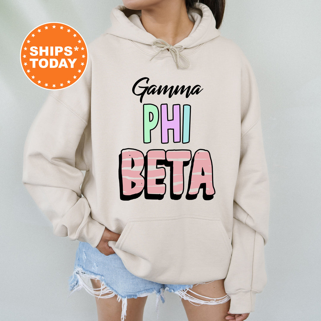 a woman wearing a white hoodie with the words gama phi beta on