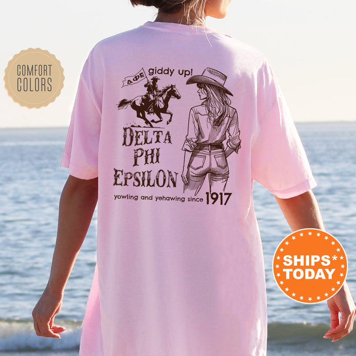 a woman wearing a pink shirt with a picture of a cowboy on it