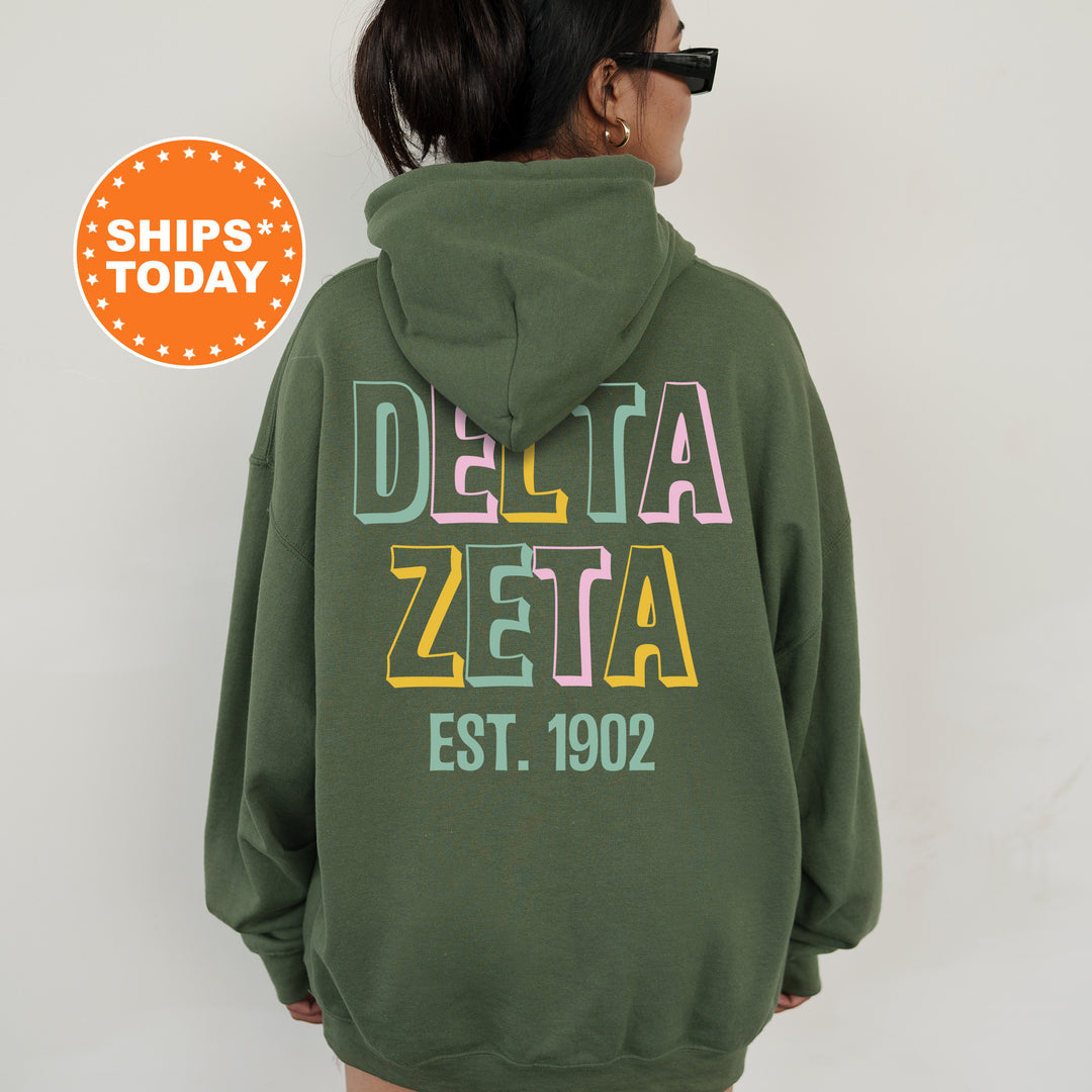 a woman wearing a green delta delta hoodie