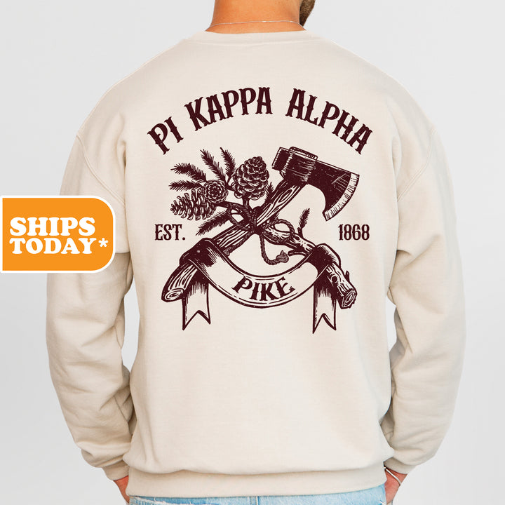 a man wearing a sweatshirt with an image of a hammer and pine cones on it