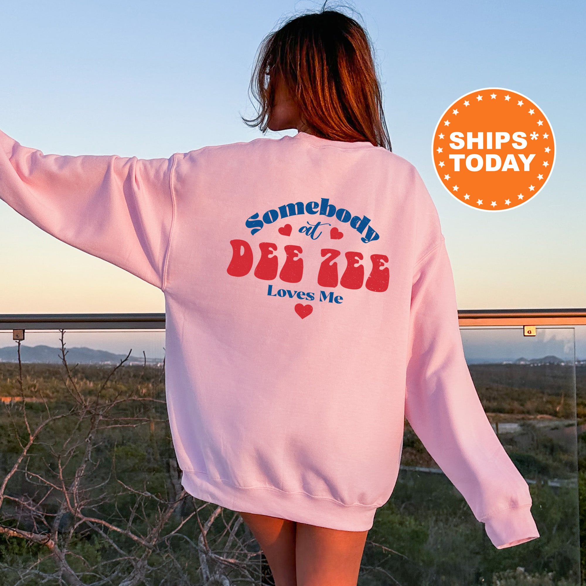 a woman wearing a pink sweatshirt with some words on it