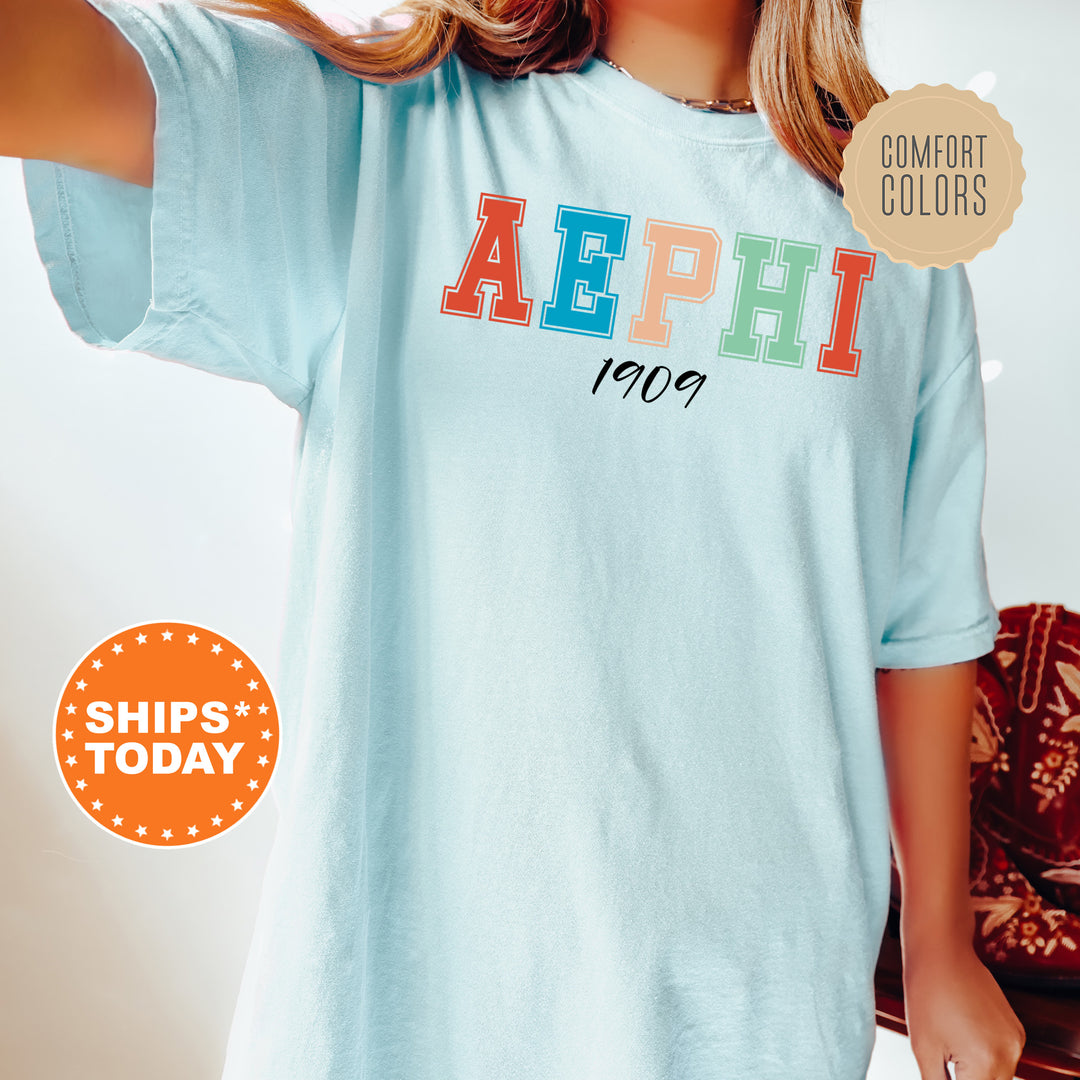 a woman wearing a light blue shirt with the word aephi printed on it