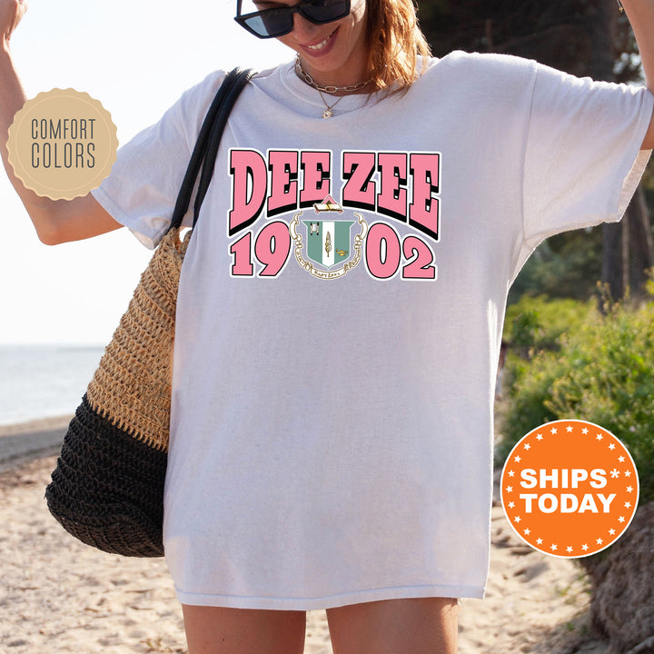 a woman wearing a white tee shirt with the words dee zeee on it