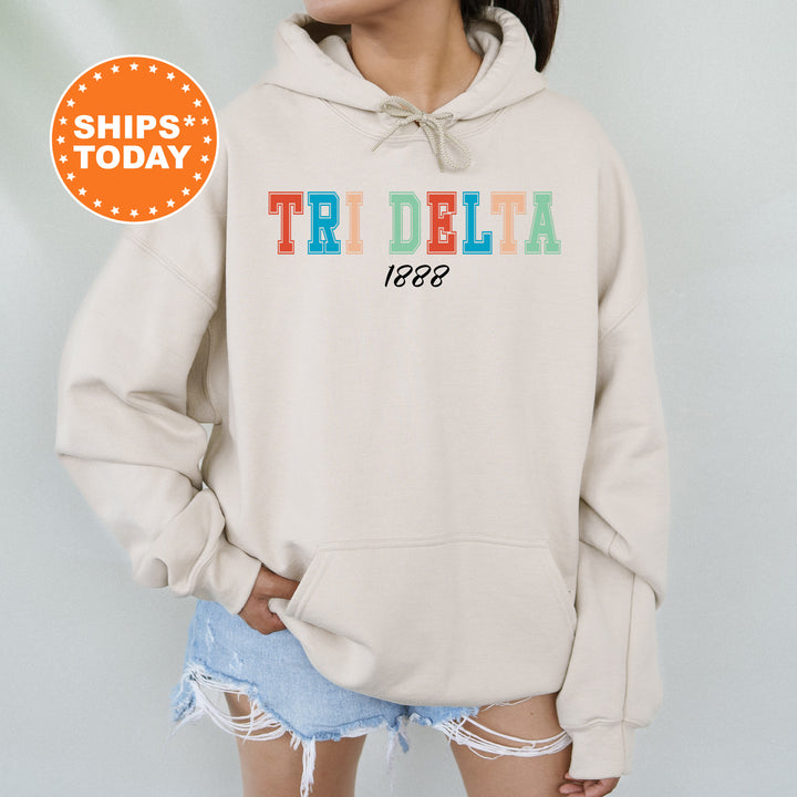 a woman wearing a sweatshirt with the word tri delta printed on it