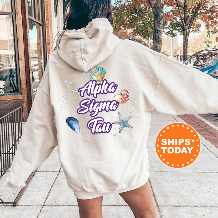 a woman walking down a sidewalk wearing a white hoodie
