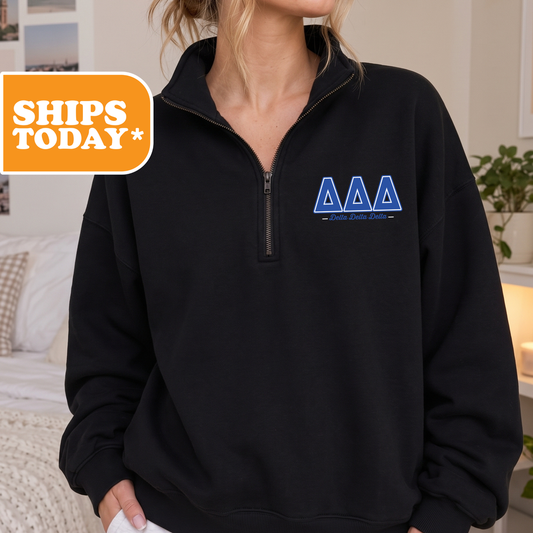 A person wearing a black sweatshirt with a logo on the left side.
