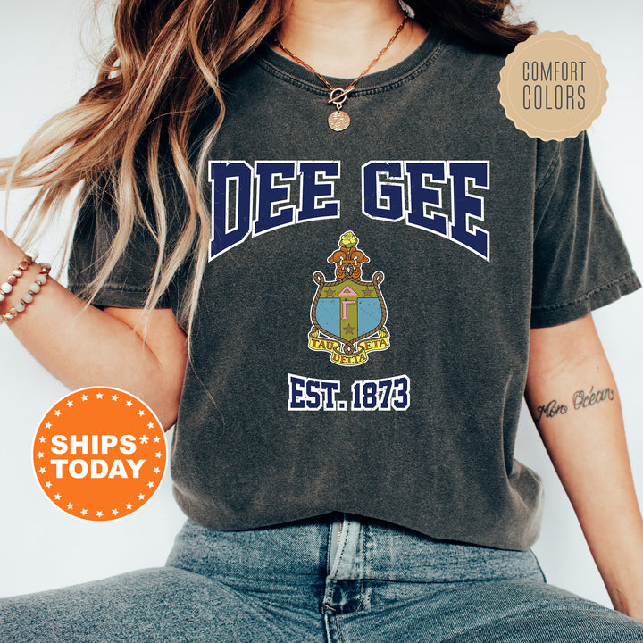 a woman wearing a t - shirt with a crest on it