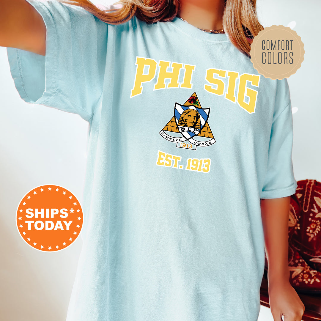 a woman wearing a blue phi sig t - shirt
