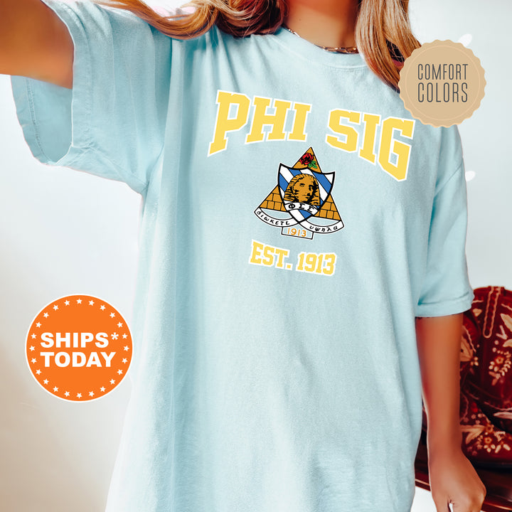 a woman wearing a blue phi sig t - shirt