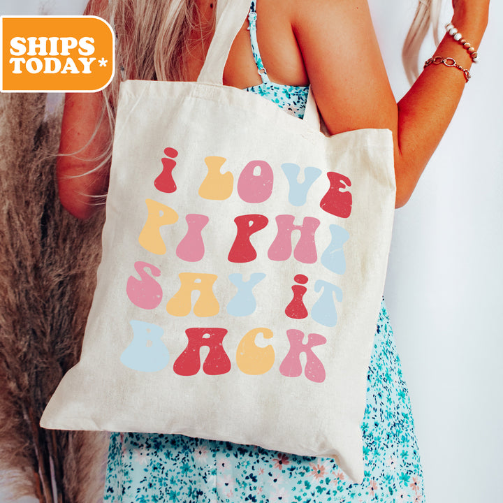 a woman holding a tote bag with a message on it